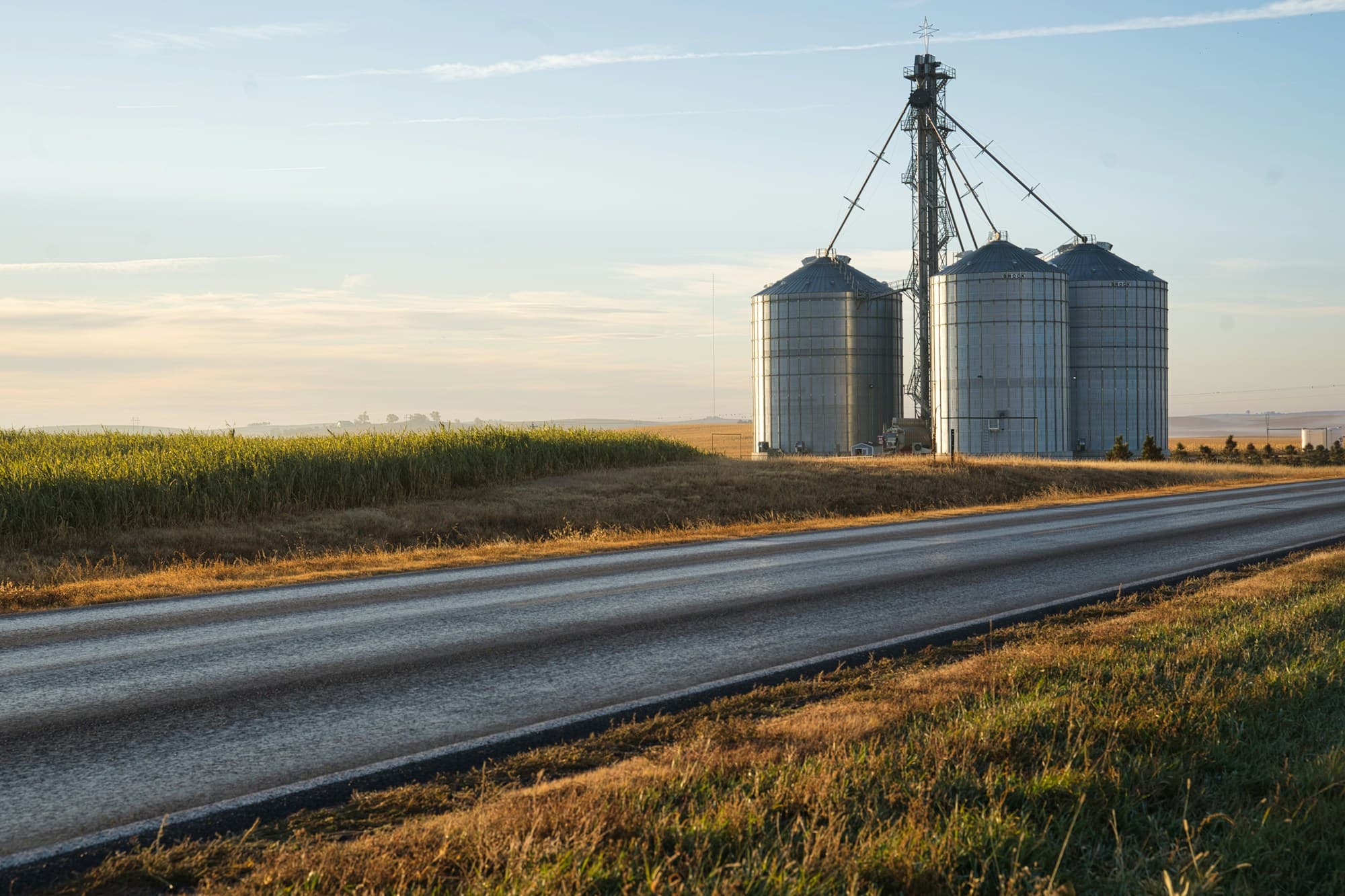 Silos de grano junto a una carretera rural al amanecer